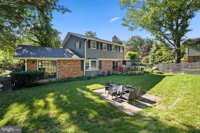 a view of a house with backyard porch and sitting area