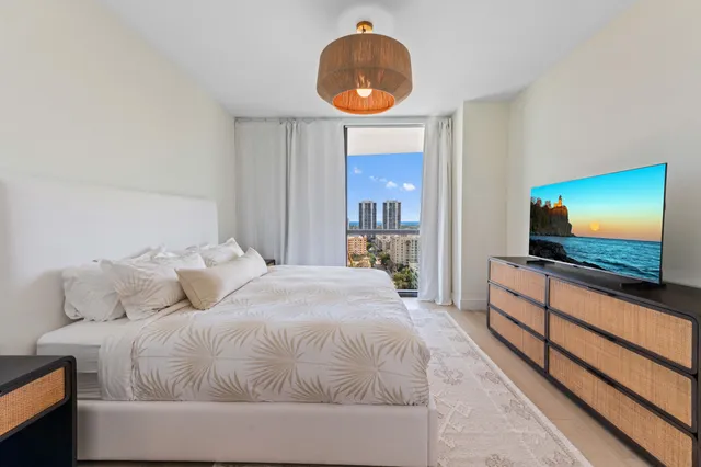 a bedroom with a bed and a flat screen tv