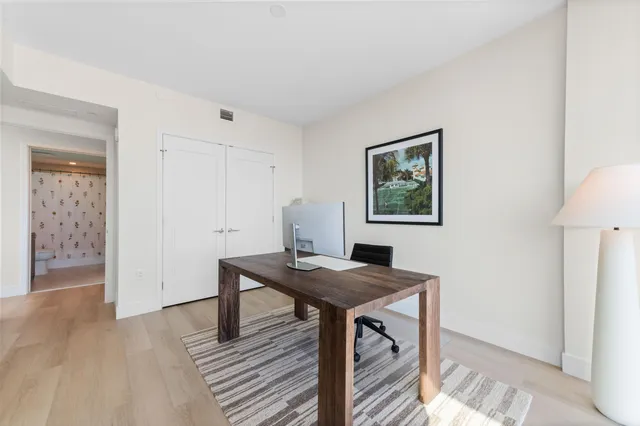 a bathroom with a sink toilet a mirror and shower curtain