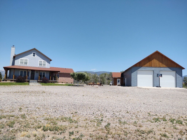 2170 Highway 357 Beaver, UT 84713 - Photo 2 of 56 Two-story residence with brick and siding exterior, a covered front porch, and an attached two-car garage