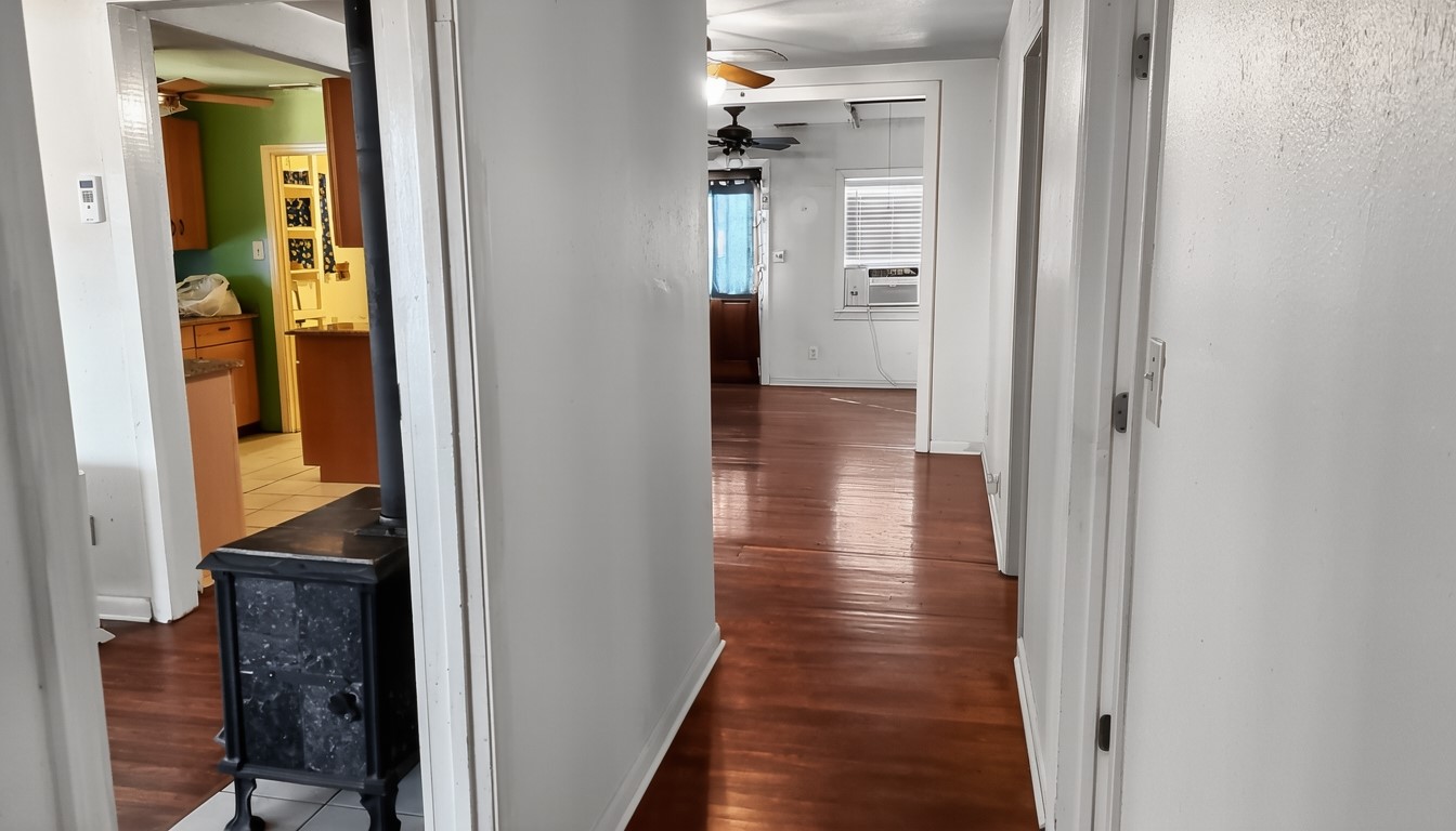 11913 McAngus Road Del Valle, TX 78617 - Photo 29 of 45 a view of a hallway with wooden floor