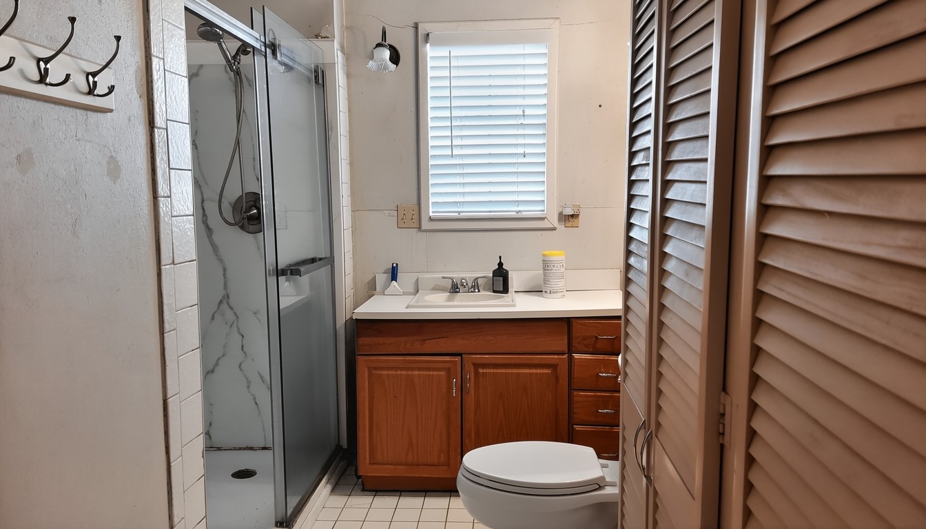 11913 McAngus Road Del Valle, TX 78617 - Photo 31 of 45 a bathroom with a sink a toilet and shower