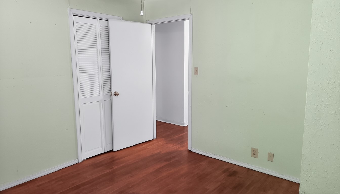 11913 McAngus Road Del Valle, TX 78617 - Photo 34 of 45 a view of an empty room with wooden floor