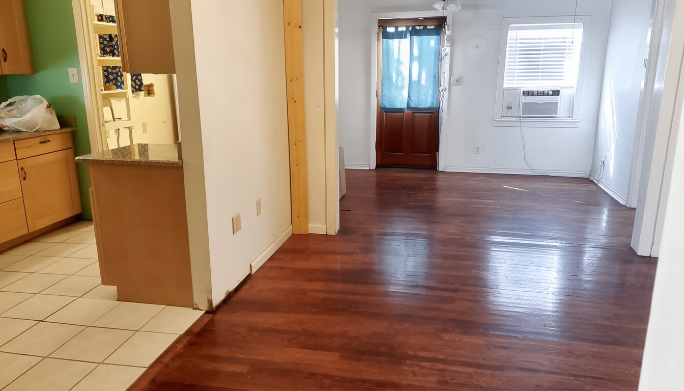 11913 McAngus Road Del Valle, TX 78617 - Photo 40 of 45 a view of a hallway with wooden floor and a bathroom