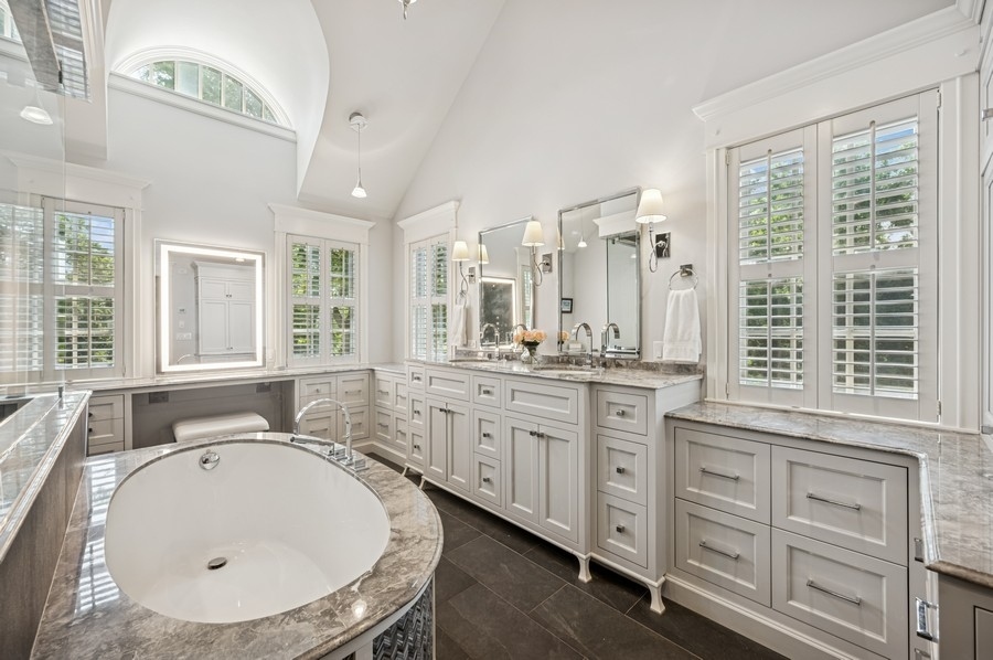 1025 Mohawk Road Wilmette, IL 60091 - Photo 19 of 47 a bathroom with a granite countertop sink mirror and a bathtub