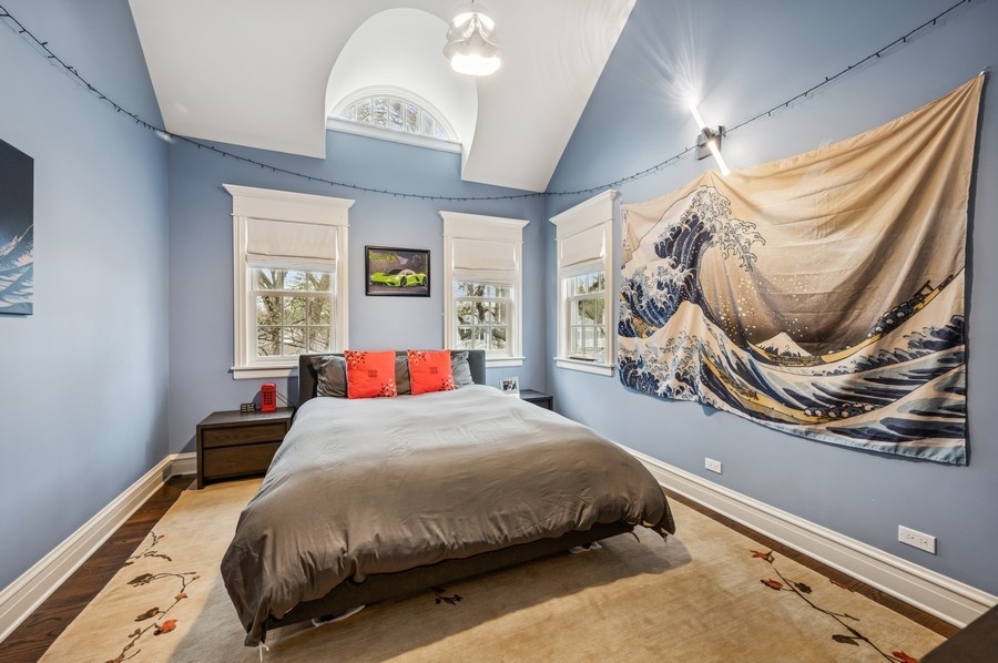 1025 Mohawk Road Wilmette, IL 60091 - Photo 24 of 47 a bedroom with a bed mirror and a window