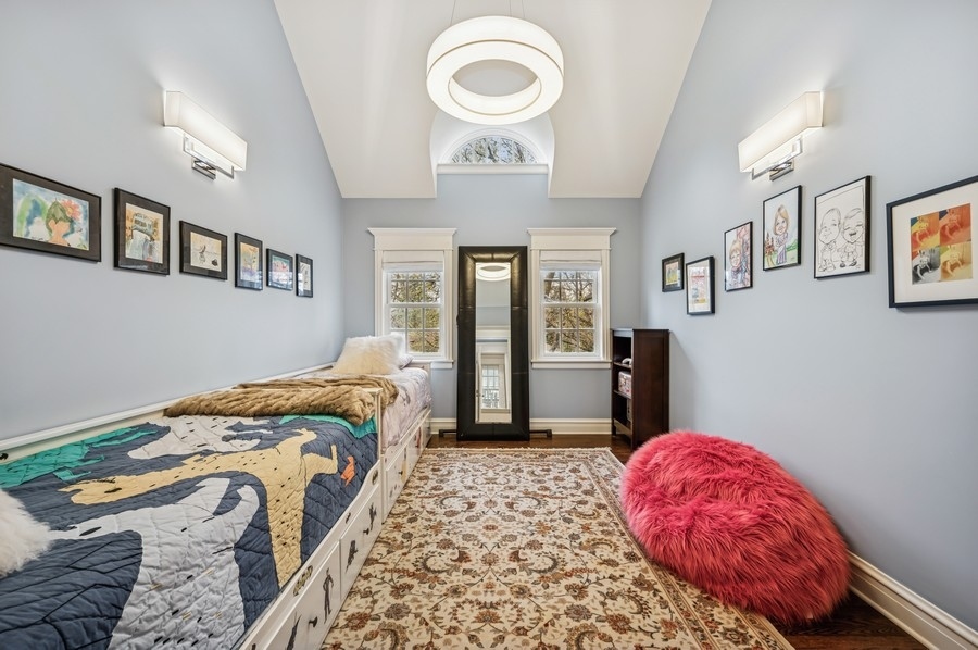 1025 Mohawk Road Wilmette, IL 60091 - Photo 25 of 47 a bedroom with a bed and a chandelier