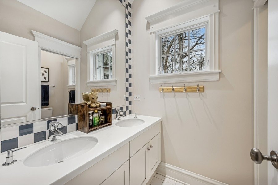 1025 Mohawk Road Wilmette, IL 60091 - Photo 29 of 47 a bathroom with a sink and a mirror