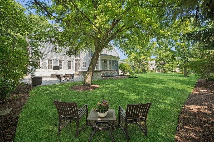 1025 Mohawk Road Wilmette, IL 60091 - Photo 42 of 47 a front view of a house with a yard table and chairs