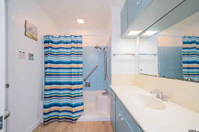 a bathroom with a sink a bathtub and a shower