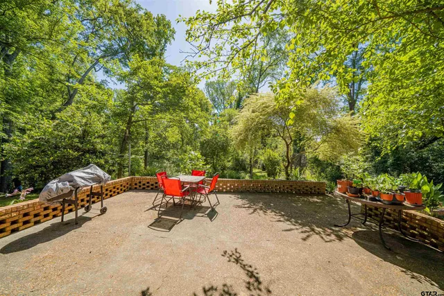 a view of a backyard with a table and chairs