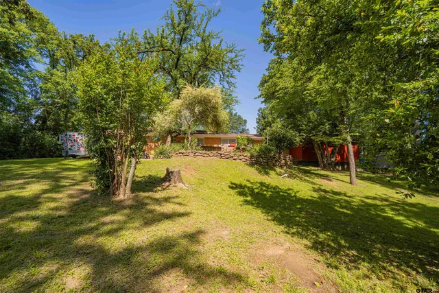 a view of a yard with swimming pool