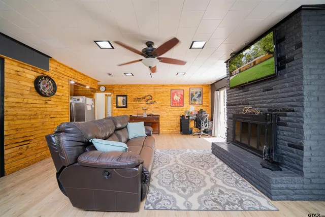 a living room with furniture a fireplace and a flat screen tv