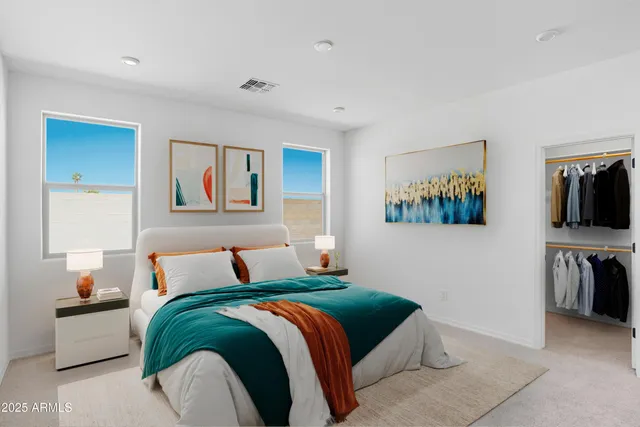 a bedroom with a bed and a television