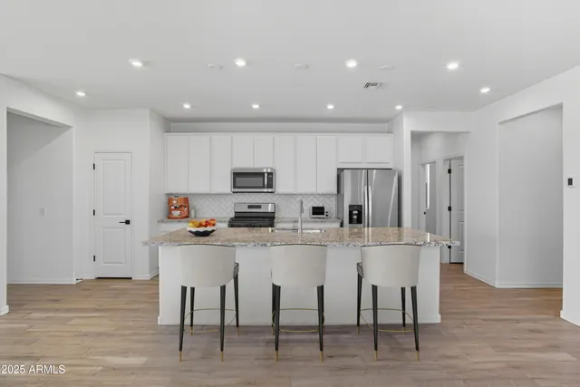 a kitchen with stainless steel appliances a refrigerator sink and microwave