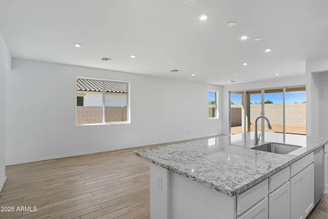 a view of kitchen and hall with wooden floor