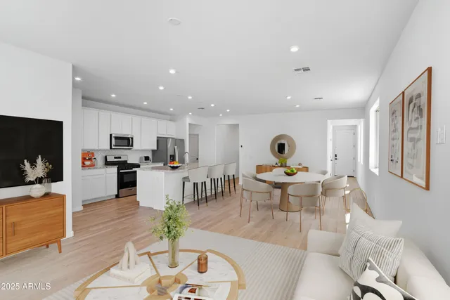 a living room with furniture a window and a flat screen tv