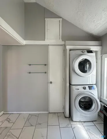 a view of a storage & utility room with washing machine