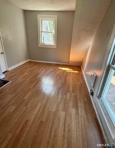 wooden floor in an empty room with a window