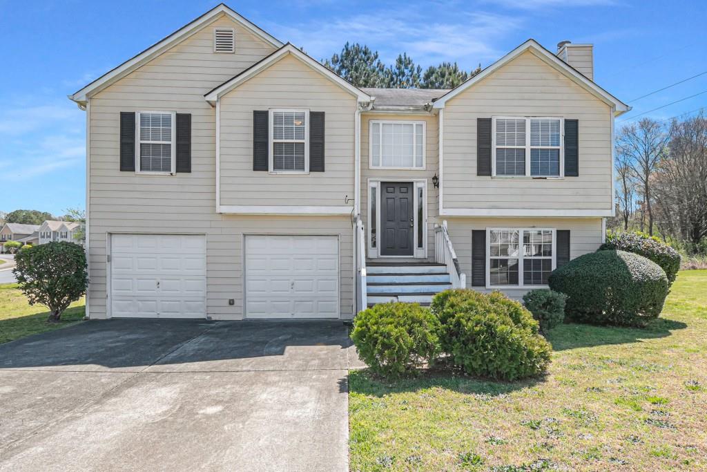 6015 Deer View Place Austell, GA 30106 - Photo 1 of 1 a view of a white house with a yard