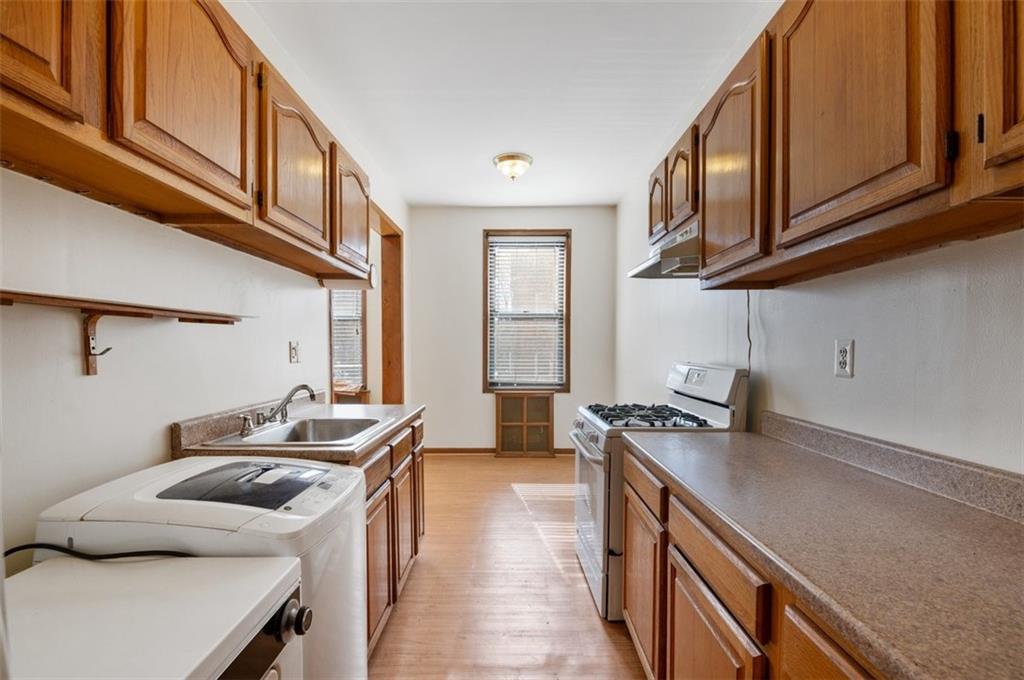 7119 Shore Road, Unit 2G Brooklyn, NY 11209 - Photo 13 of 22 a kitchen with stainless steel appliances granite countertop a stove and a sink