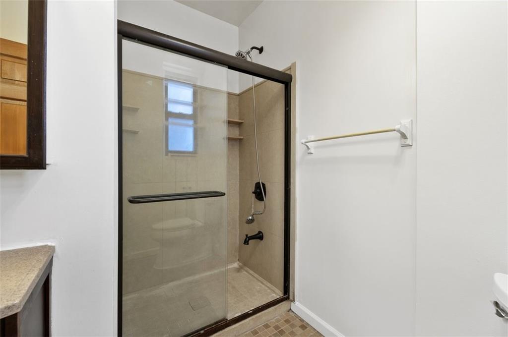 7119 Shore Road, Unit 2G Brooklyn, NY 11209 - Photo 16 of 22 a bathroom with a glass shower door