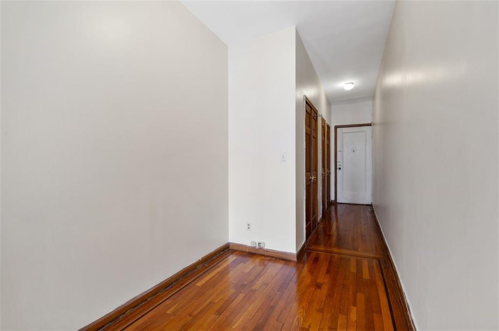 7119 Shore Road, Unit 2G Brooklyn, NY 11209 - Photo 9 of 22 a view of a hallway with wooden floor