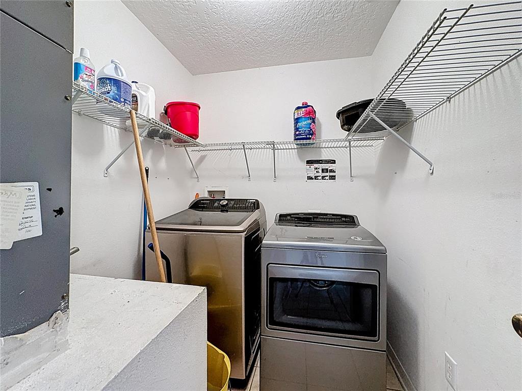 2620 Hunley Loop Kissimmee, FL 34743 - Photo 21 of 52 a kitchen with a stove and a refrigerator