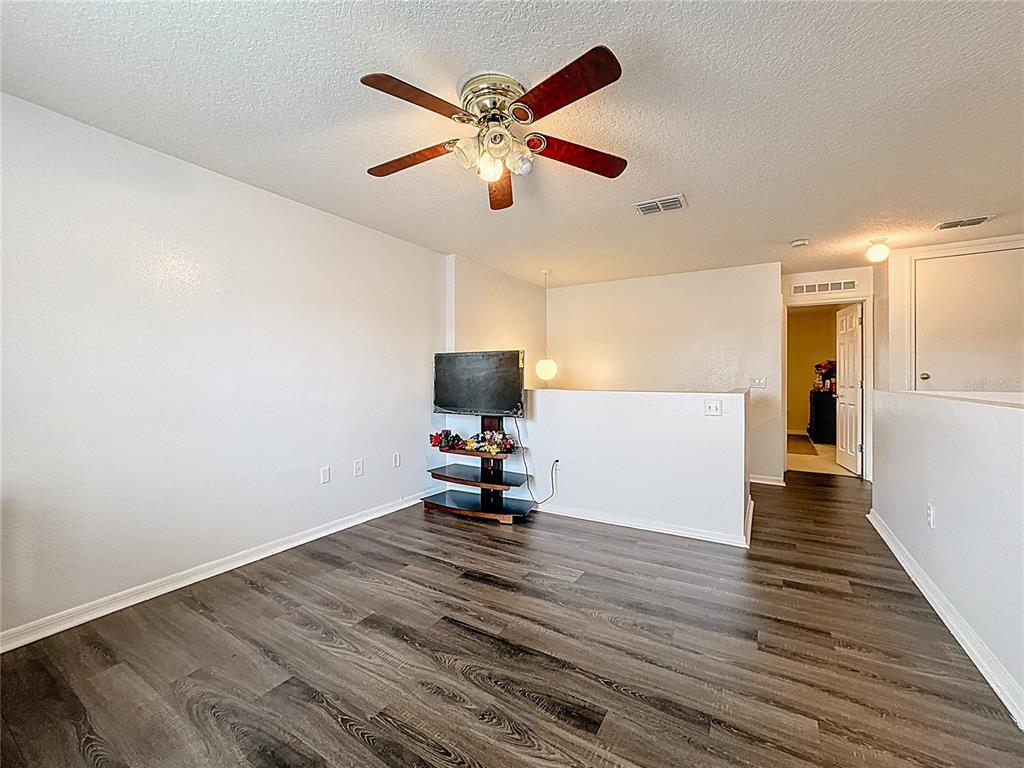 2620 Hunley Loop Kissimmee, FL 34743 - Photo 22 of 52 a view of an empty room with wooden floor