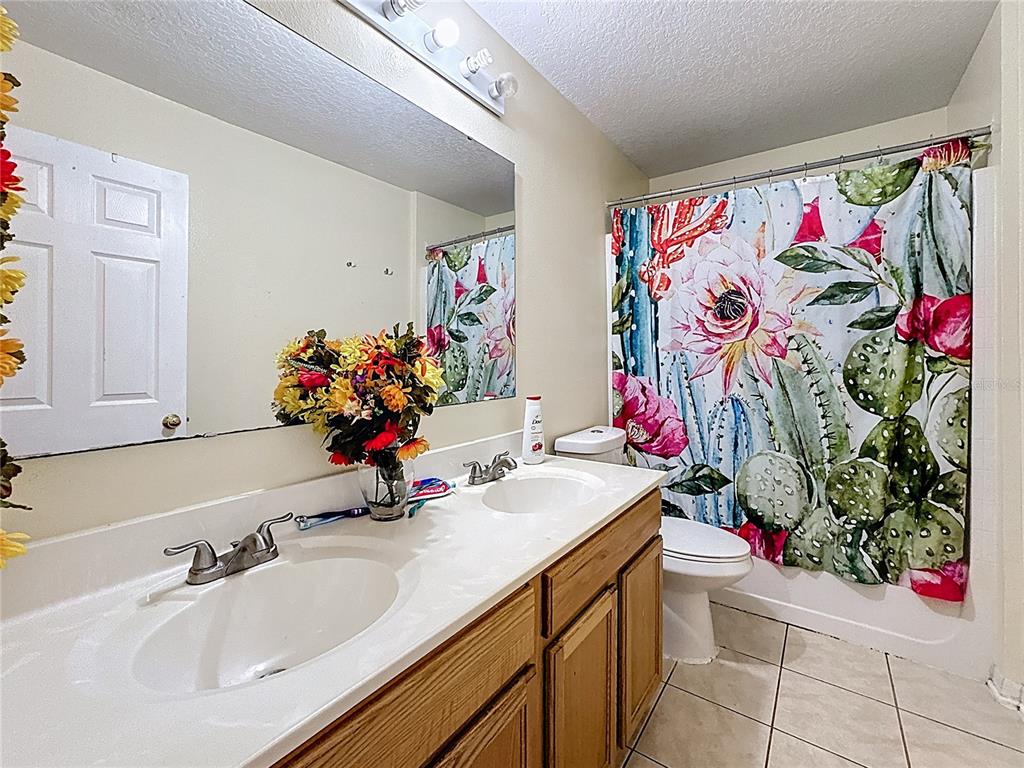 2620 Hunley Loop Kissimmee, FL 34743 - Photo 29 of 52 a bathroom with a sink mirror and vanity