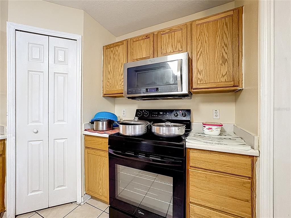2620 Hunley Loop Kissimmee, FL 34743 - Photo 36 of 52 a kitchen with stainless steel appliances granite countertop a stove and a microwave