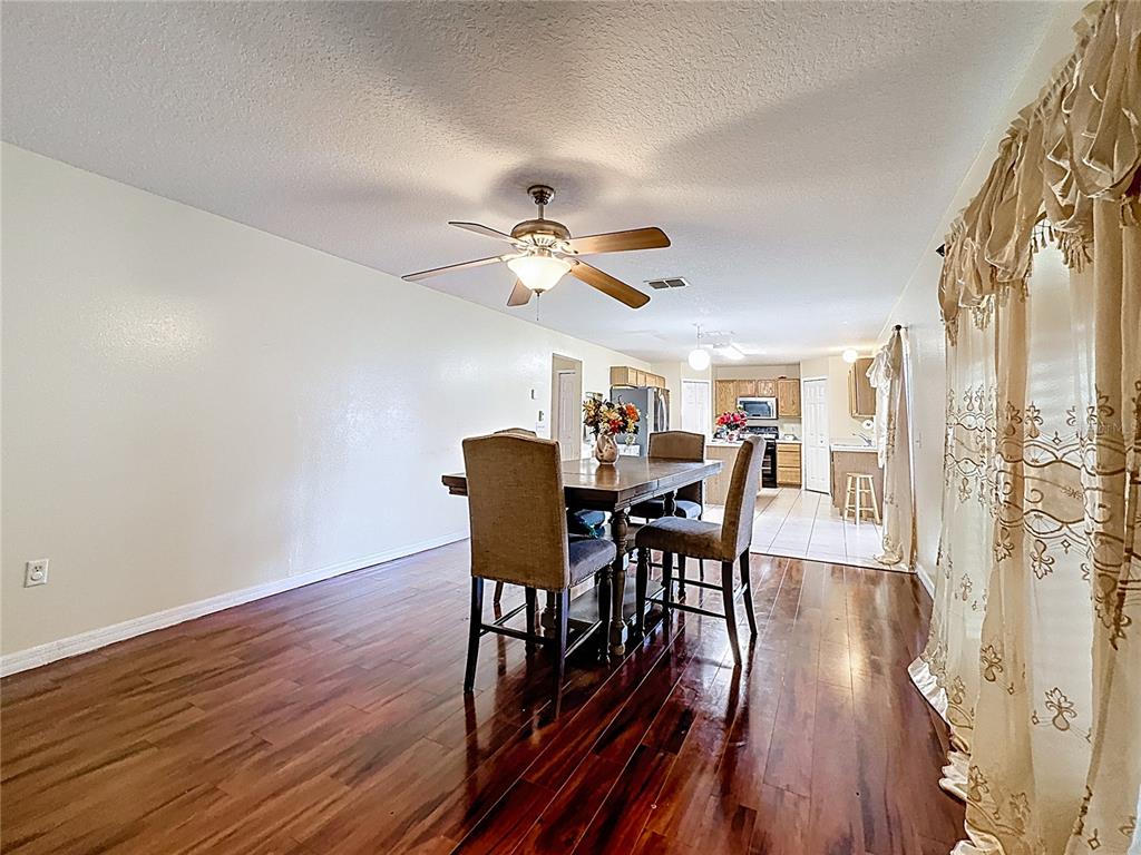 2620 Hunley Loop Kissimmee, FL 34743 - Photo 38 of 52 a view of a dining room with furniture window and wooden floor