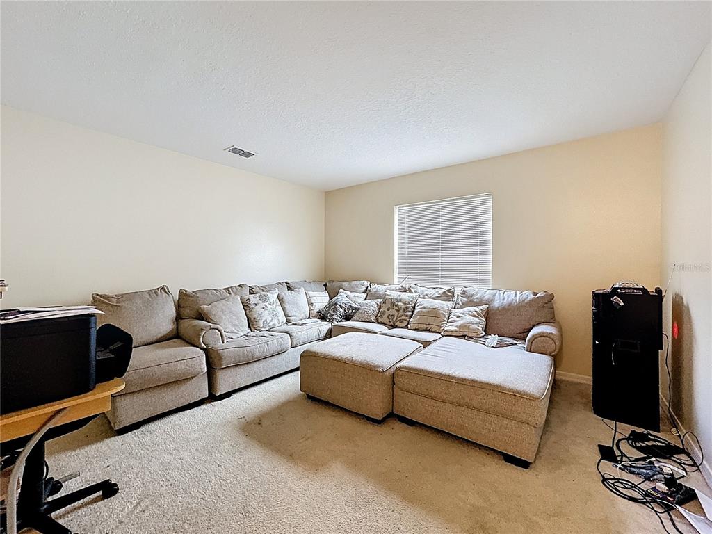 2620 Hunley Loop Kissimmee, FL 34743 - Photo 39 of 52 a hotel room with large bed and a couch