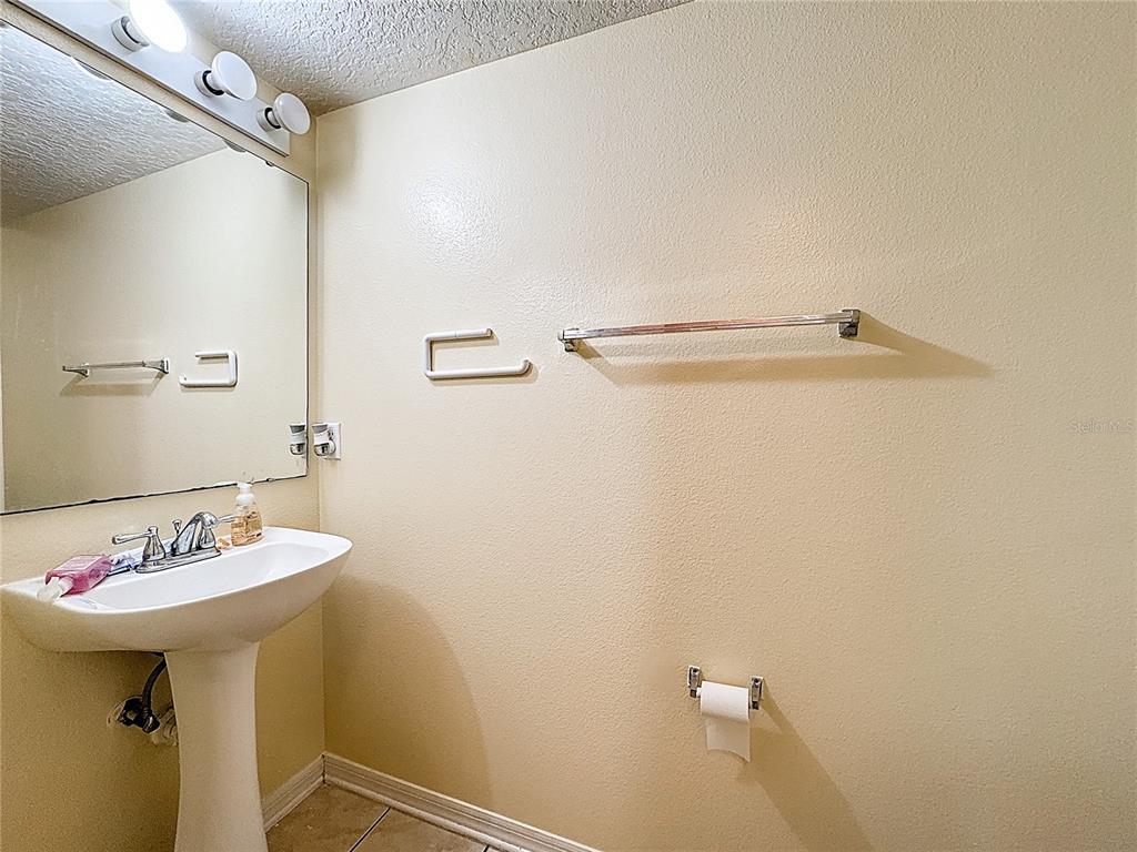 2620 Hunley Loop Kissimmee, FL 34743 - Photo 41 of 52 a bathroom with a sink and a mirror