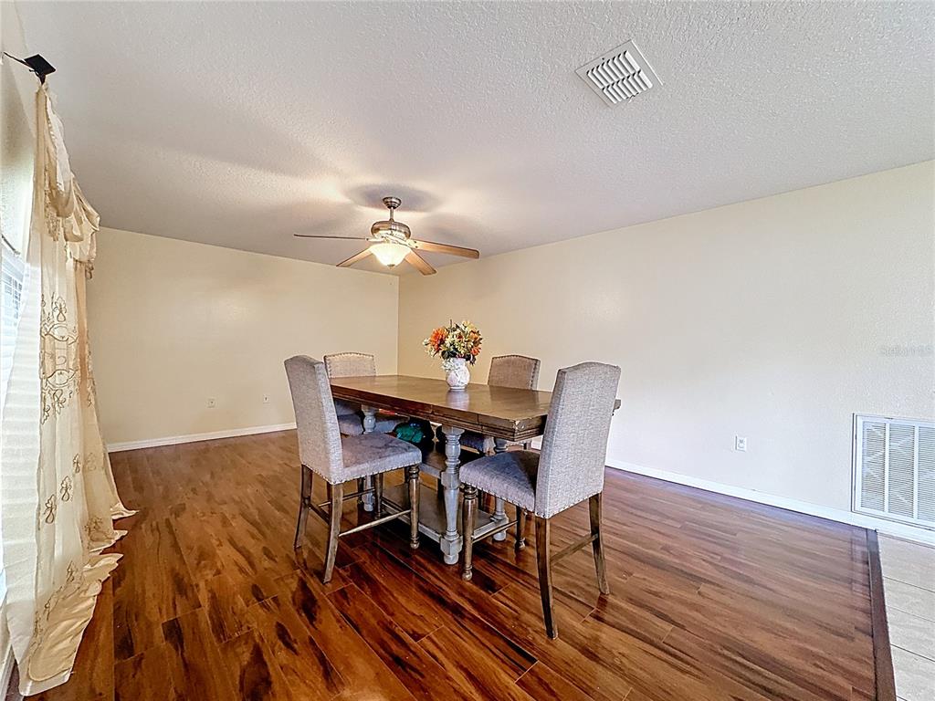 2620 Hunley Loop Kissimmee, FL 34743 - Photo 7 of 52 a view of a dining room with furniture and wooden floor