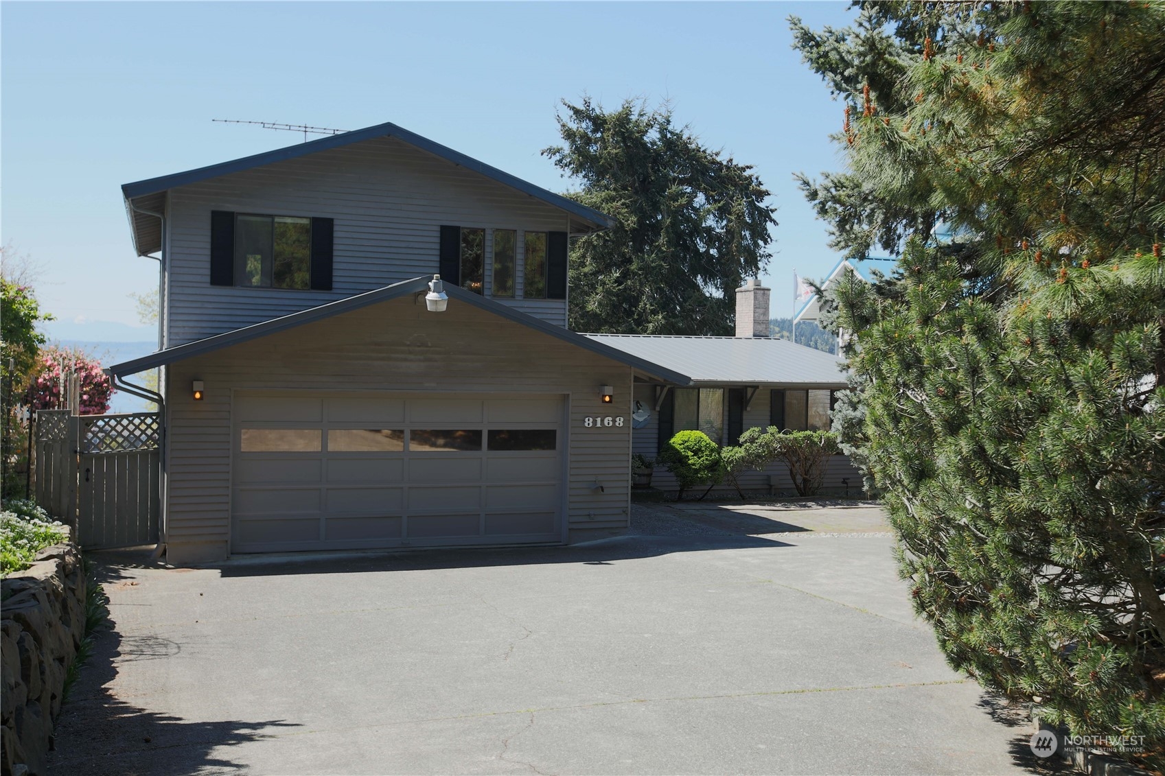 8168 Cultus Bay Road Clinton, WA 98236 - Photo 2 of 38 a front view of a house with a yard and garage