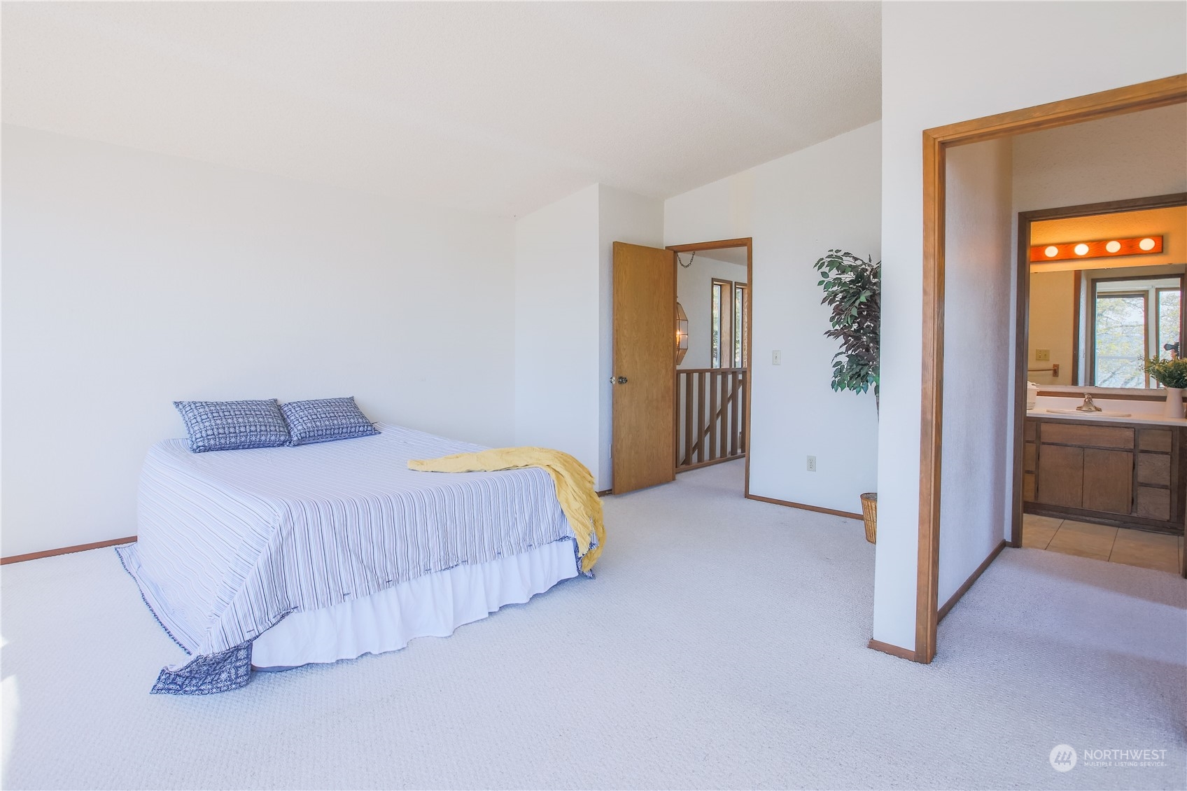8168 Cultus Bay Road Clinton, WA 98236 - Photo 22 of 38 a bedroom with a bed and a view of bathroom