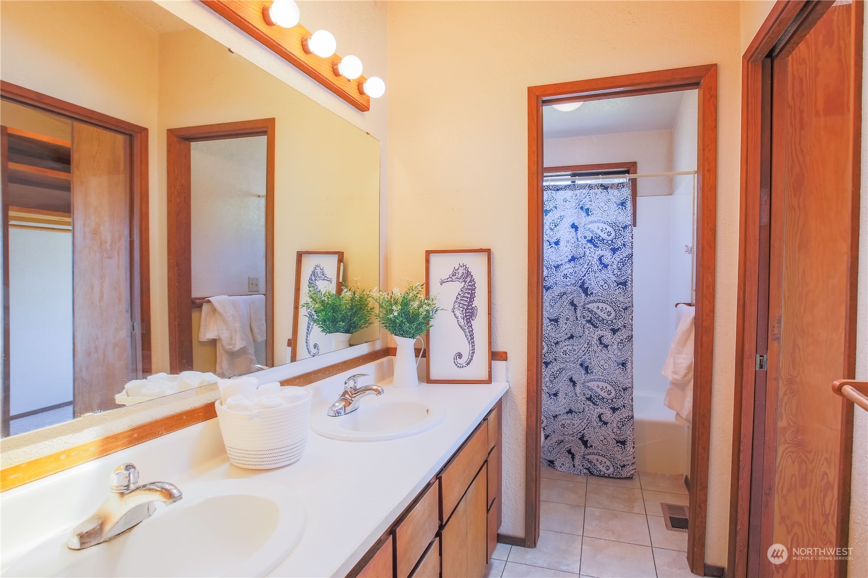 8168 Cultus Bay Road Clinton, WA 98236 - Photo 23 of 38 a bathroom with a sink mirror and a bath tub
