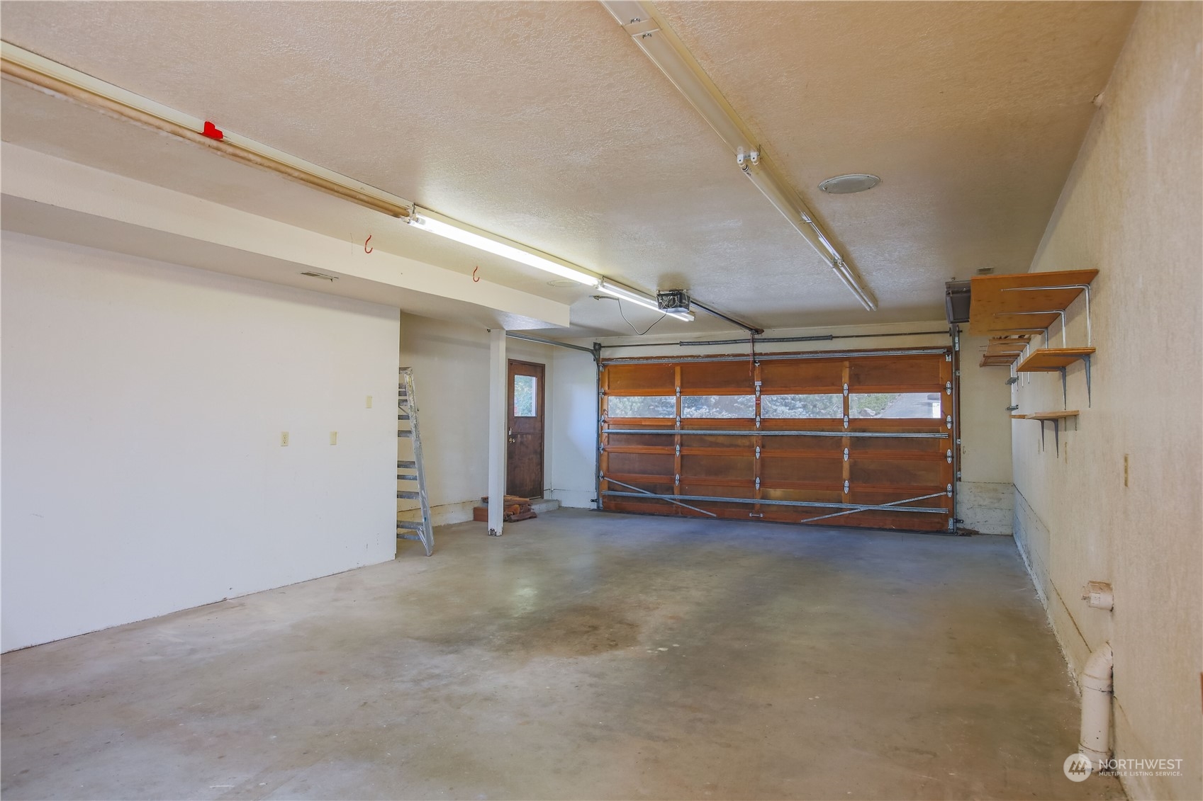 8168 Cultus Bay Road Clinton, WA 98236 - Photo 27 of 38 a view of empty room with wooden floor and windows
