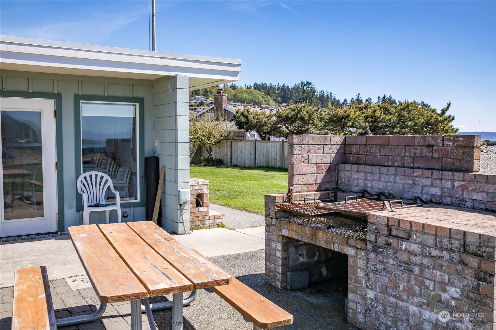 8168 Cultus Bay Road Clinton, WA 98236 - Photo 36 of 38 a view of a patio with table and chairs with wooden floor and fence