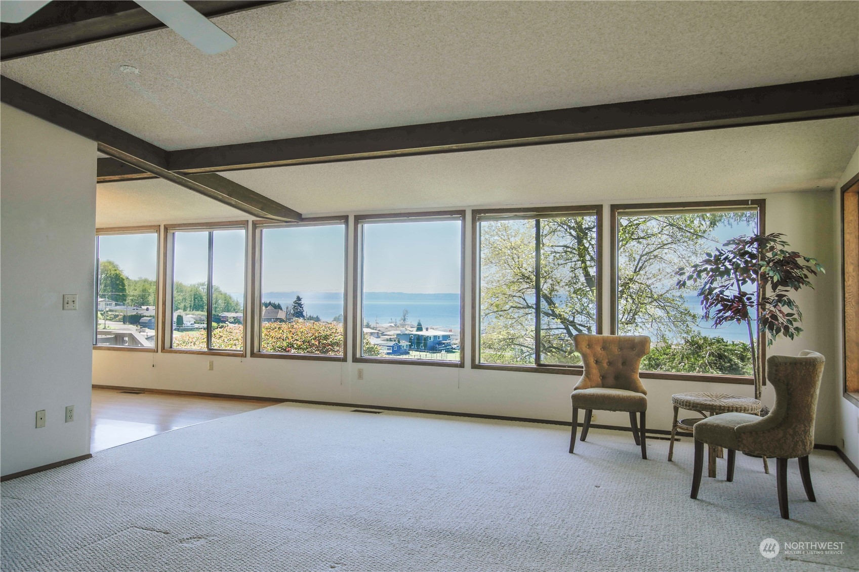 8168 Cultus Bay Road Clinton, WA 98236 - Photo 6 of 38 a living room with furniture and a large window