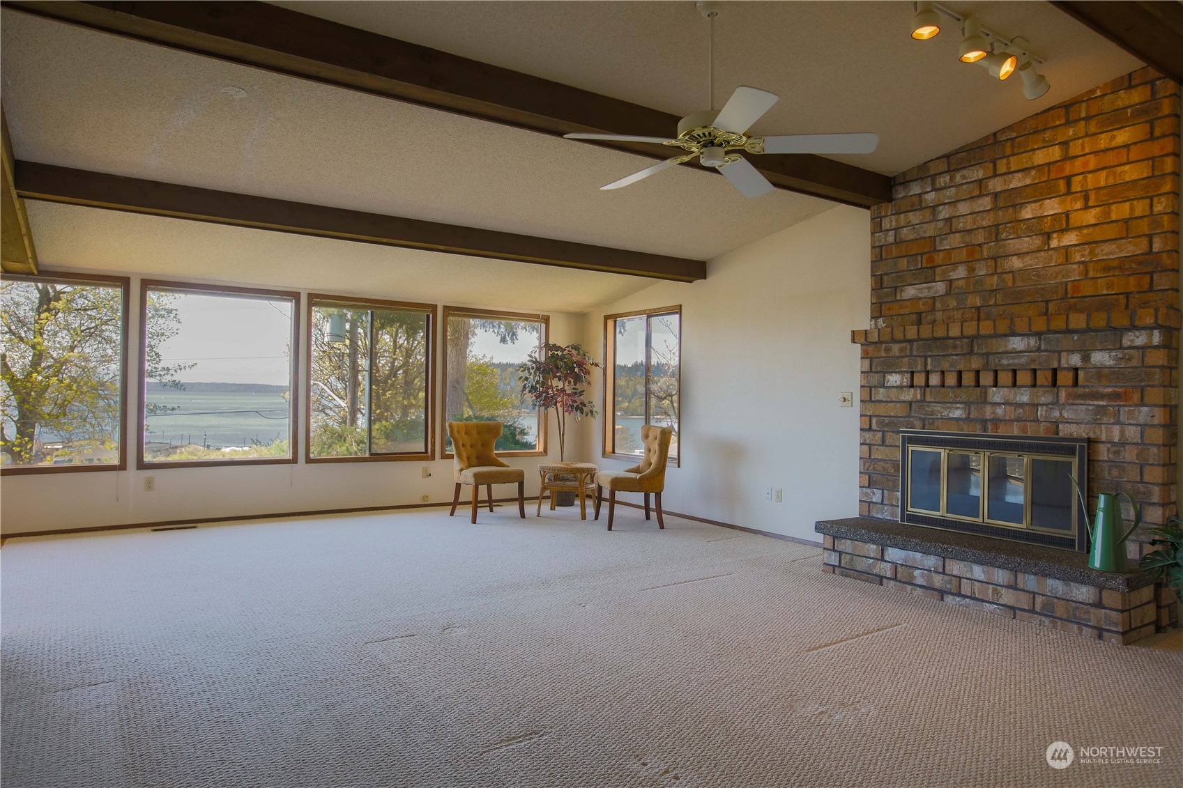 8168 Cultus Bay Road Clinton, WA 98236 - Photo 7 of 38 a living room with furniture and a fireplace