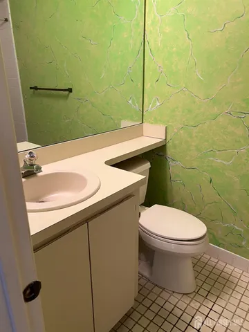 a bathroom with a sink a toilet and mirror
