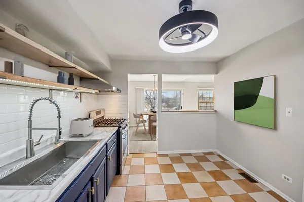 a kitchen with a sink a stove and cabinets