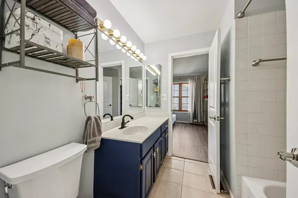 a en suite bathroom with a sink and a large mirror