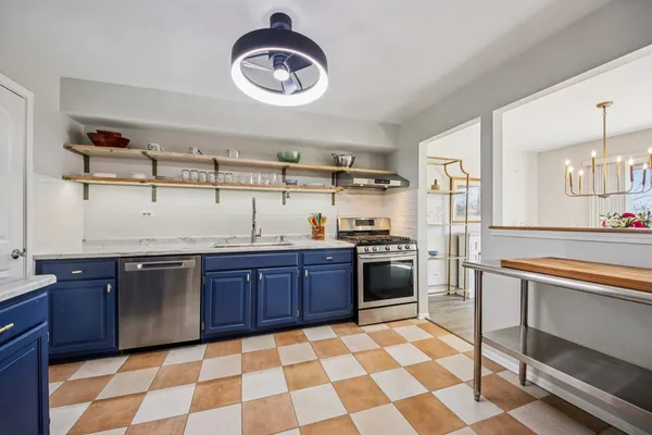 a kitchen with granite countertop stainless steel appliances a sink and a counter top space