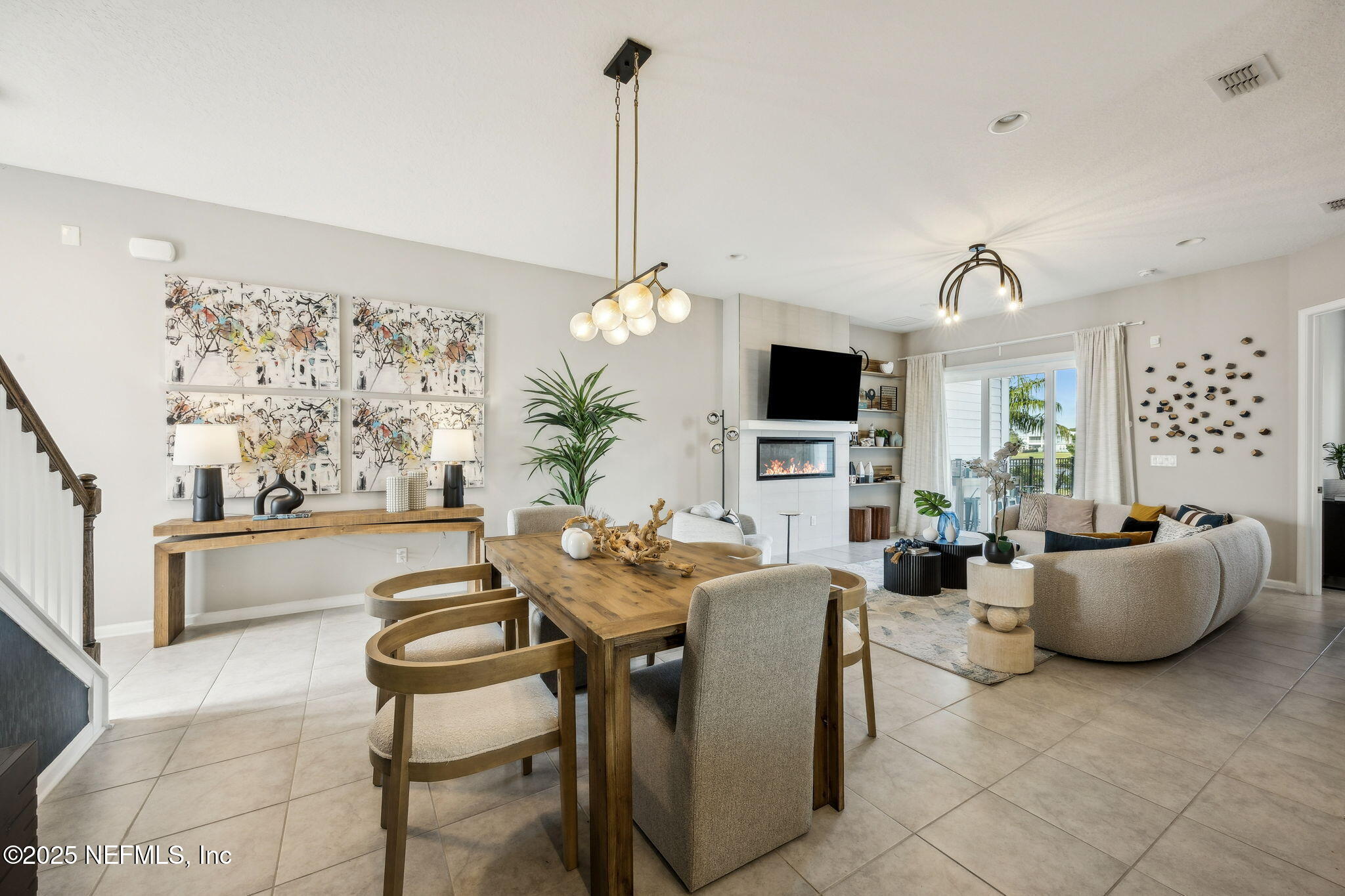 290 Rum Runner Way St. Johns, FL 32259 - Photo 17 of 105 a living room with furniture a flat screen tv and a large window