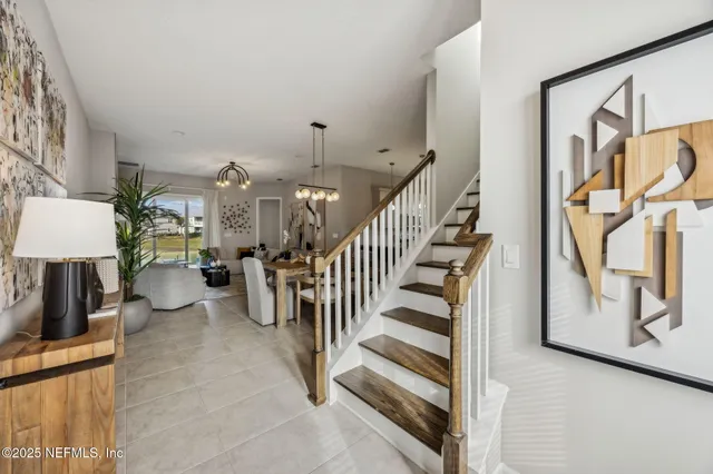 a bedroom with a bed a flat screen tv and a book shelf