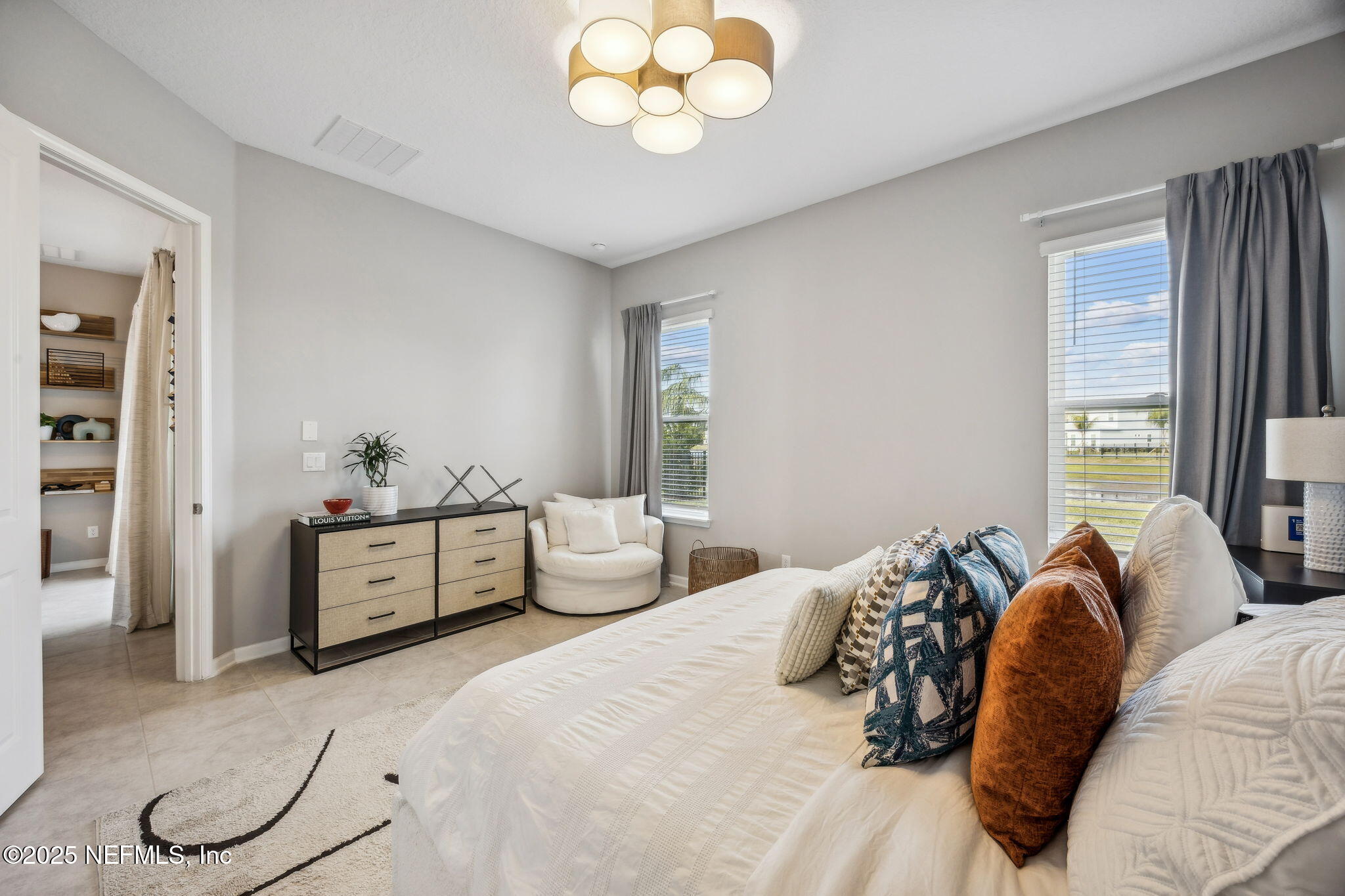 290 Rum Runner Way St. Johns, FL 32259 - Photo 29 of 105 a bedroom with a bed and a chandelier