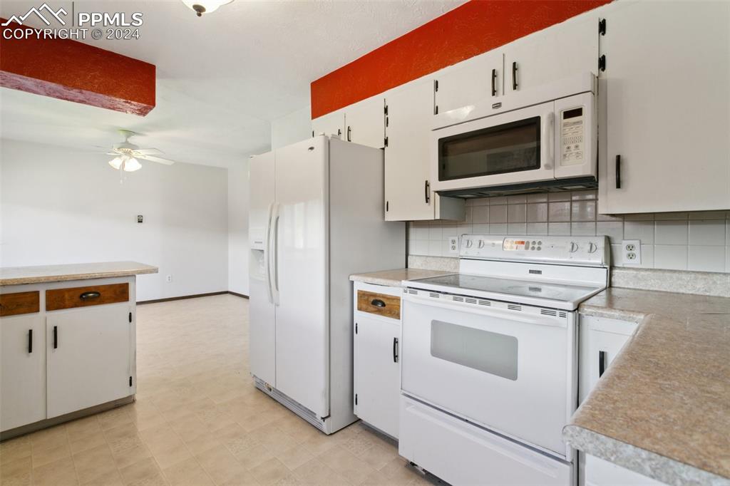 519 Dakota Avenue Simla, CO 80835 - Photo 14 of 27 a kitchen with stainless steel appliances white cabinets and a stove